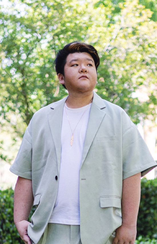 Samuel Peng outdoors in a light green jacket